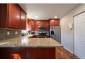 Beautiful kitchen with stainless steel appliances, granite counters, and ample cabinet space at 4673 S Lowell Blvd, Denver, CO 80236