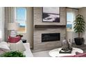 Cozy living room showcases a modern fireplace, neutral decor, and natural light for a relaxing atmosphere at 9186 Telluride Ct, Commerce City, CO 80022