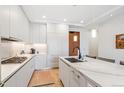 Modern kitchen with quartz countertops, white cabinets, stainless steel appliances, and hardwood floors at 1901 Wazee St # 504, Denver, CO 80202