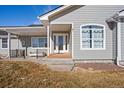 Inviting front entrance to this grey home, with covered porch and beautiful front door at 51 W 6Th Pl, Byers, CO 80103