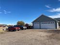 Spacious two-car garage with an extended driveway and parking, offering ample space for vehicles and storage at 51 W 6Th Pl, Byers, CO 80103