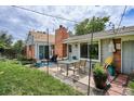 Relaxing backyard area featuring a patio, outdoor seating, string lights, and a well-maintained lawn at 9220 Lowell Blvd, Westminster, CO 80031