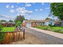 Attractive home featuring well-kept lawn, inviting driveway, and colorful flowers at 9220 Lowell Blvd, Westminster, CO 80031