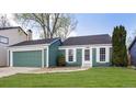 Charming single-Gathering home features green siding, a two-car garage, and a well-maintained lawn at 19644 E Girard Dr, Aurora, CO 80013