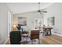 Bright open-concept living and dining area with wood floors, ceiling fan and modern furniture at 19644 E Girard Dr, Aurora, CO 80013