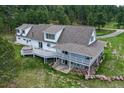 Spacious home featuring an expansive covered deck and walkout basement situated on a lush lot at 3619 Estates Cir, Larkspur, CO 80118