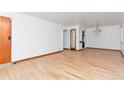 Spacious living room featuring hardwood floors and a vintage chandelier at 3515 Grape St, Denver, CO 80207