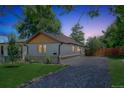 Inviting home exterior with a well-kept lawn, stone driveway, and natural wood accents at 710 Raleigh St, Denver, CO 80204