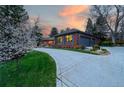 Stunning brick home with attached garage and elegant driveway at sunset at 4031 S Hudson Way, Cherry Hills Village, CO 80113