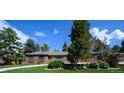 Charming single-story home with a brick facade and lush green lawn at 4031 S Hudson Way, Cherry Hills Village, CO 80113