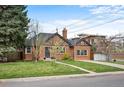 Beautiful brick home featuring a lush green lawn, mature trees, and a welcoming entrance at 795 N Jersey St, Denver, CO 80220
