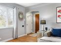 Inviting living room with hardwood floors, a sunburst mirror, and a cozy seating arrangement at 795 N Jersey St, Denver, CO 80220