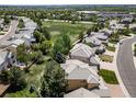 Expansive aerial view of a residential neighborhood with a large green space and a variety of homes at 5416 S Hannibal Ct, Centennial, CO 80015