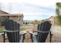 Scenic backyard view with Adirondack chairs, professionally landscaped yard, and mountain views at 10526 Fairhurst Way, Highlands Ranch, CO 80126