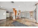 Building lobby area featuring marble flooring, wood columns, a mail room, and decorative lighting fixtures at 2225 Buchtel Blvd # 208, Denver, CO 80210