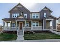 Two-story house with a inviting porch, showcasing a home's design and exterior appeal at 3534 N Meadows Dr, Castle Rock, CO 80109