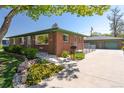 A well-kept brick home with a detached two car garage and a beautifully landscaped front yard at 4530 S Inca St, Englewood, CO 80110