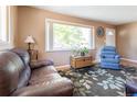 Cozy living room with hardwood floors, a large window, and neutral paint tones at 4530 S Inca St, Englewood, CO 80110