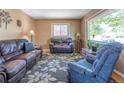 Spacious living room featuring two leather sofas, an accent rug, and natural light at 4530 S Inca St, Englewood, CO 80110