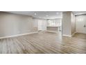Open-concept living area features hardwood flooring, neutral walls, and seamless flow into the kitchen and entry at 363 Lima St, Aurora, CO 80010