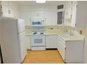 Bright kitchen with white cabinets and appliances offering a clean and functional space at 695 S Alton Way # 6B, Denver, CO 80247