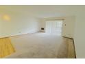 Spacious living room featuring neutral carpet and a sliding door for plenty of natural light at 695 S Alton Way # 6B, Denver, CO 80247