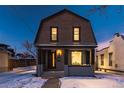 Evening view of the home's exterior, showcasing updated siding and landscaping at 2031 W 37Th Ave, Denver, CO 80211