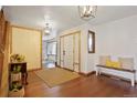 Bright foyer featuring hardwood floors, stylish lighting, and a welcoming bench at 1331 Alpine St, Longmont, CO 80504