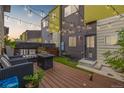 Charming outdoor patio with comfortable seating, string lights, and a well-manicured lawn at 2824 W Parkside Pl, Denver, CO 80221