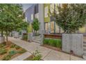 Street view of modern townhomes with well-maintained landscaping and contemporary design elements at 2824 W Parkside Pl, Denver, CO 80221