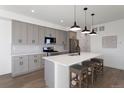 Contemporary kitchen featuring gray cabinetry, stainless steel appliances, and a quartz countertop island at 4650 W 9Th Ave, Denver, CO 80204