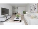 Open living room with stylish furniture, modern decor, and seamless flow into the dining area at 7801 W 35Th Ave # 406, Wheat Ridge, CO 80033