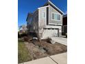 Two-story home featuring a two-car garage and professionally landscaped front yard at 9756 Ash Ln, Thornton, CO 80229