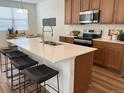 Beautiful kitchen with an island, stainless steel appliances, and modern bar stools at 9756 Ash Ln, Thornton, CO 80229