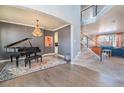 Open-concept living area with staircase, hardwood floors, neutral walls, and bright, natural light at 2879 Hilltop Ct, Broomfield, CO 80023