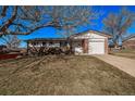 Charming single-Gathering home with a brick facade, attached garage, and a well-maintained front yard at 2813 S Ivan Way, Denver, CO 80227