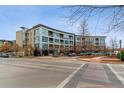 Modern building exterior with ample parking at 2958 Syracuse St # 303, Denver, CO 80238