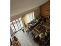 Open living room featuring large windows, neutral carpet, and comfortable seating at 4484 Juniper Ct, Larkspur, CO 80118