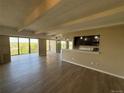 Sunlit living room with hardwood floors and access to balcony, seamlessly connects to the kitchen at 7865 E Mississippi Ave # 706, Denver, CO 80247