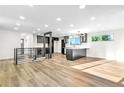 Spacious open-concept living room and kitchen featuring hardwood floors and abundant natural light at 220 S Raleigh St, Denver, CO 80219