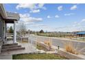 Street view of house showcasing a manicured front yard and neighborhood amenities nearby at 6595 Meade Ct, Arvada, CO 80003