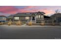 Charming home exterior showcasing the well-manicured lawn, tasteful landscaping, and inviting entrance at 6595 Meade Ct, Arvada, CO 80003