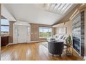 Bright living area with hardwood floors, fireplace, and sun-filled windows at 6595 Meade Ct, Arvada, CO 80003