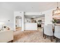 Open floor plan of living room leading to the kitchen at 5726 N Genoa Way # 204, Aurora, CO 80019