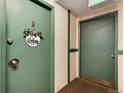 Apartment entrance with welcome sign and dual green doors at 2325 S Linden Ct # 101, Denver, CO 80222