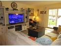 Comfortable living room with a fireplace, TV, and sliding glass doors to the outside at 2325 S Linden Ct # 101, Denver, CO 80222