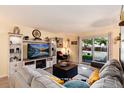 Inviting living room with a comfortable sofa, entertainment center, and sliding doors to the patio at 2325 S Linden Ct # 101, Denver, CO 80222