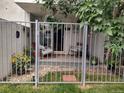 Enclosed patio featuring rocking chairs, potted plants, and a decorative metal fence at 2325 S Linden Ct # 101, Denver, CO 80222