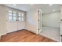 Open foyer featuring hardwood floors, a pair of French doors and a view to the carpeted living space at 3310 S Oneida Way, Denver, CO 80224