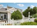 Charming exterior view of home with a white picket fence and lush greenery at 2408 Concord Cir, Lafayette, CO 80026